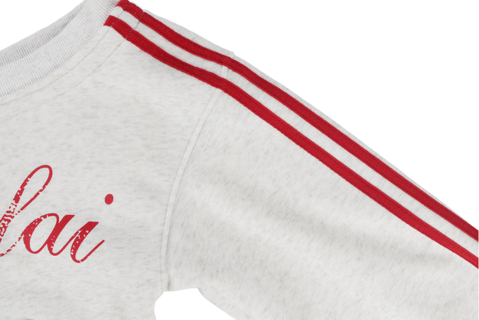 Close-up of white hoodie sleeve with red double stripes along the shoulder and arm