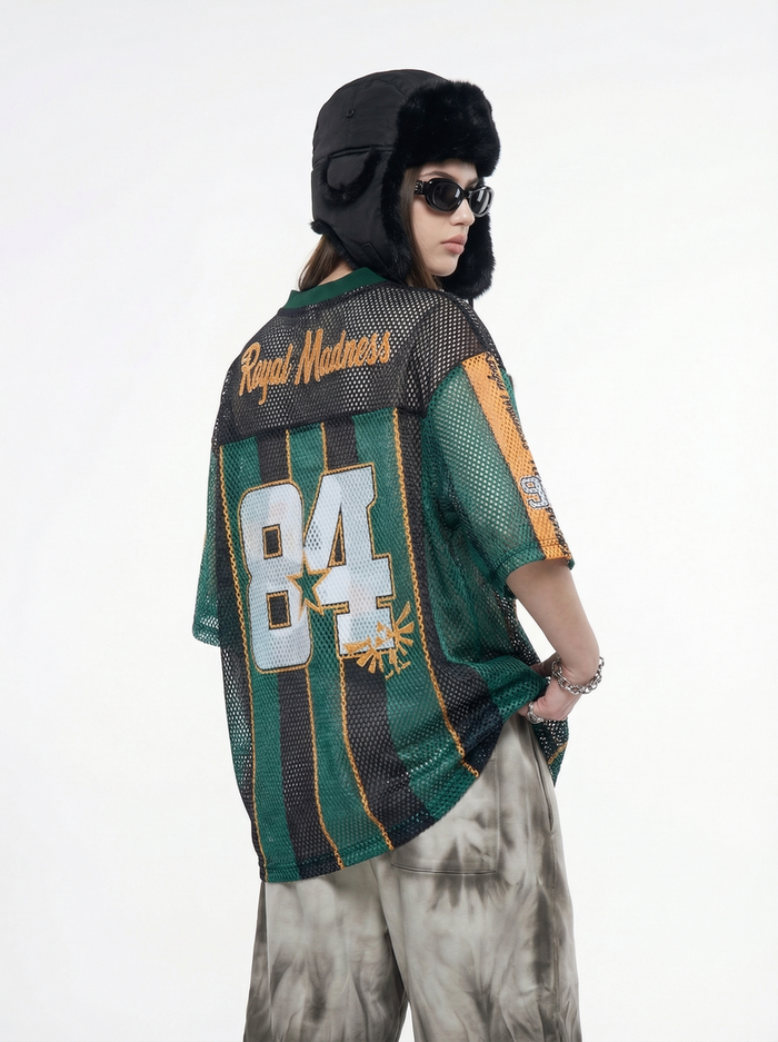 Green and black mesh jersey T-shirt with 84 graphic and Royal Madness lettering, worn with streetwear styling