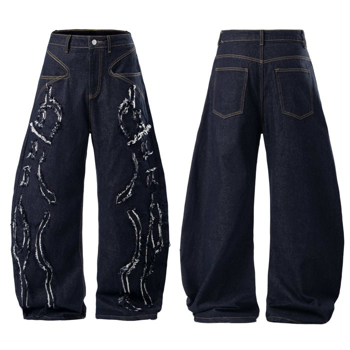 Front and back view of dark indigo baggy jeans with frayed white flame appliqué panels and contrast stitching
