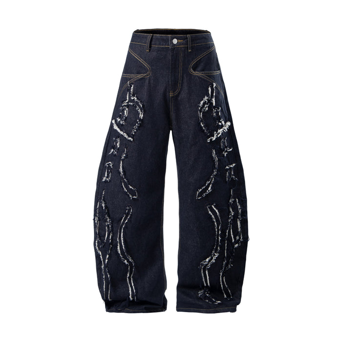 Dark baggy jeans front view with flame-shaped distressed patches and yellow contrast stitching