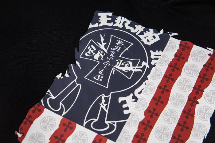 Close-up of front graphic on black hoodie showing iron cross emblem and flag print