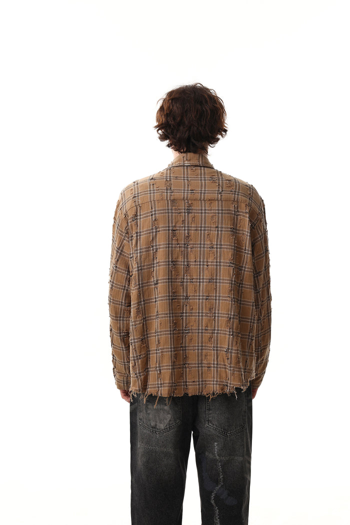 Back view of tan distressed plaid shirt jacket on model with frayed hem