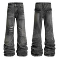 Front and back view of grey distressed studded stacked denim jeans with ripped knees and pyramid stud waistband