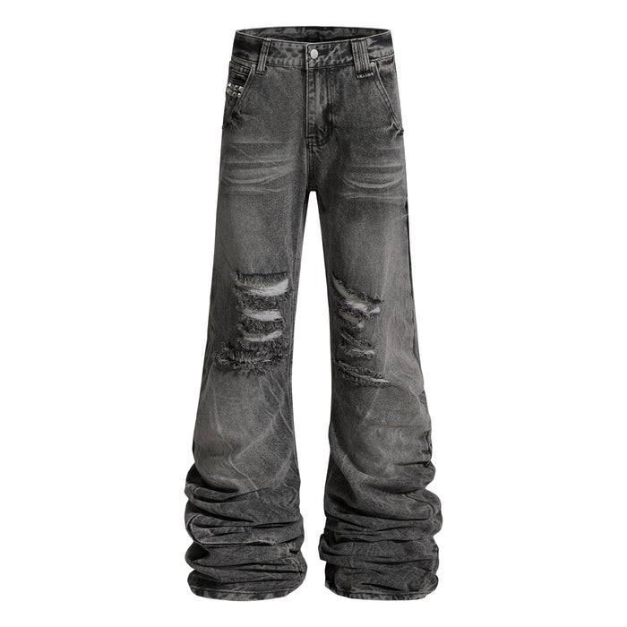 Front view of distressed gray-black jeans with stacked legs and ripped knees