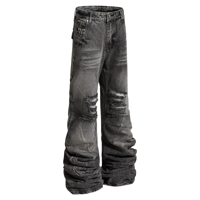 Angled front view of distressed stacked denim pants with studded pocket detail
