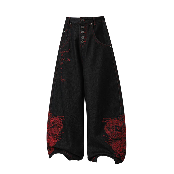 Front view of black wide-leg denim pants with red dragon embroidery and script detail