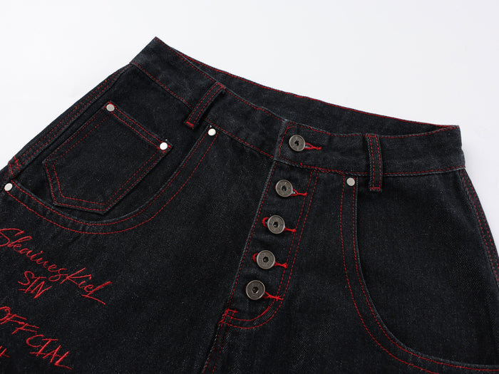 Close-up of front waistband with button fly, belt loops, red stitching, and front pocket