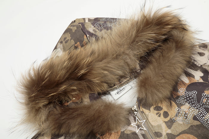 Close-up of fur-trimmed hood on camouflage jacket with star zipper pull and rhinestone details