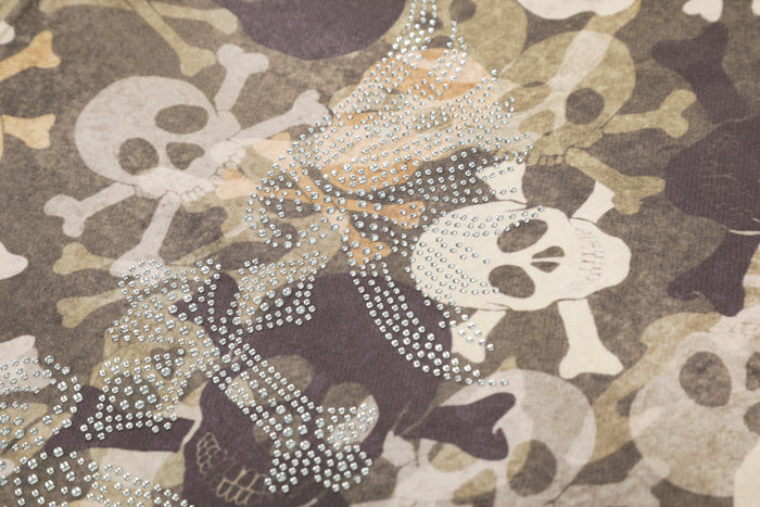 Close-up of rhinestone skull graphic on camouflage bomber hoodie jacket