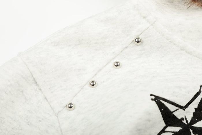 Close-up of white sleeve with silver stud details and stitched seam