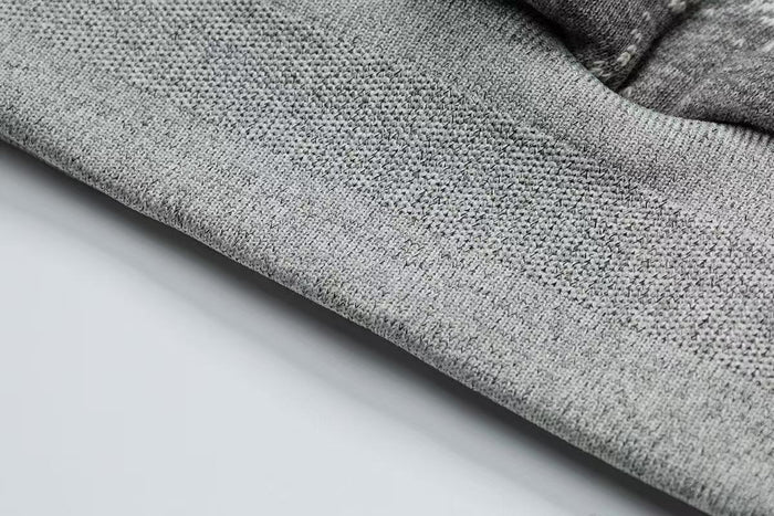 Close-up of gray fleece-lined ribbed hem on the hoodie