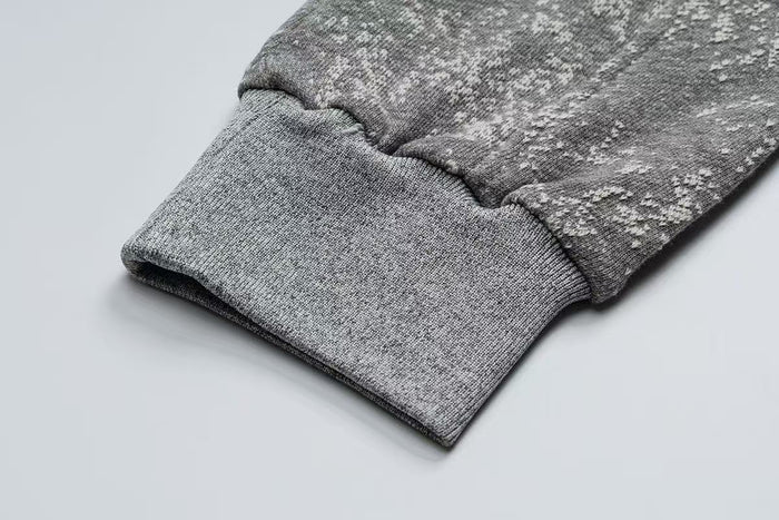 Close-up of gray ribbed sleeve cuff on the starburst hoodie