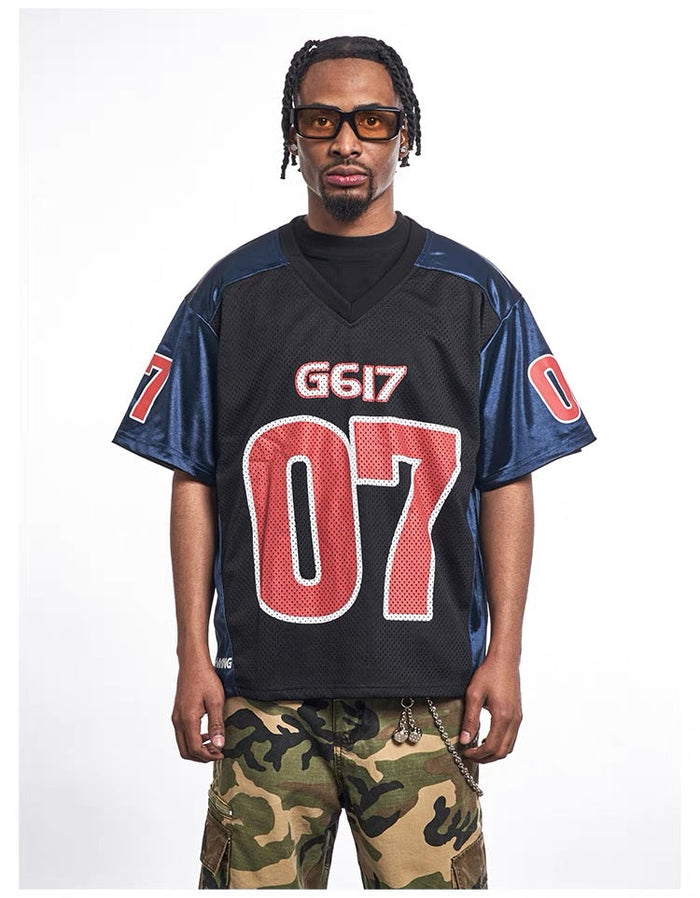 Oversized black mesh varsity jersey tee with blue sleeves and bold red G617 07 graphics on model