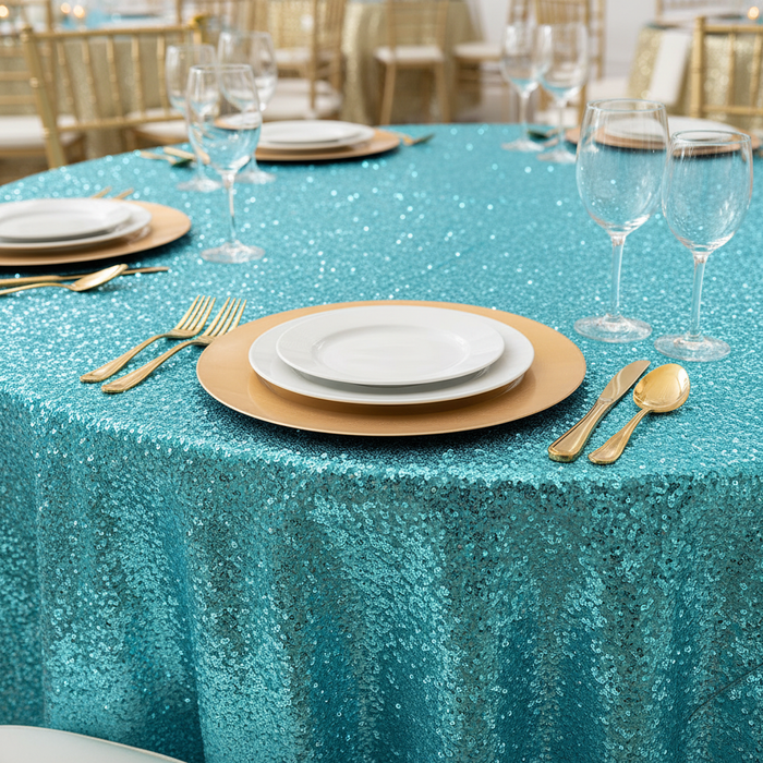 Glitz Sequins 120" Round Tablecloth - Turquoise close up view with gold charger plate