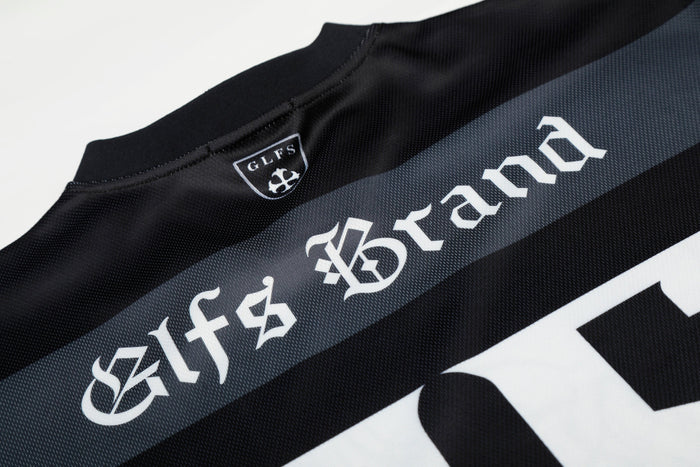 Black mesh football jersey with gothic-style white lettering and a small GLFS crest at the collar