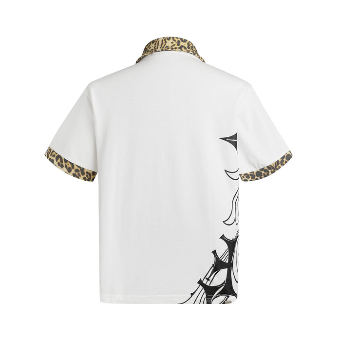 White short-sleeve polo shirt with leopard print collar and cuffs, featuring black gothic cross graphics on the back