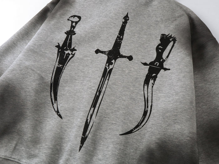 Close-up of gray hoodie back print with three black sword graphics on heather fabric