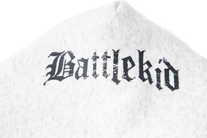 Close-up of hood on white hoodie with distressed black gothic lettering across the back