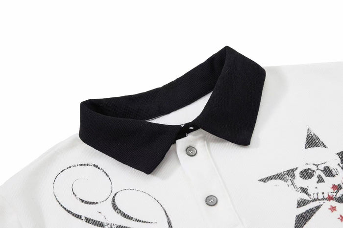 White polo shirt with black contrast collar and gothic skull and star graphic print on the chest