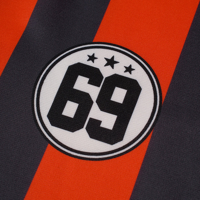 Close-up of a black and orange striped football jersey with a circular No. 69 badge and stars on the chest