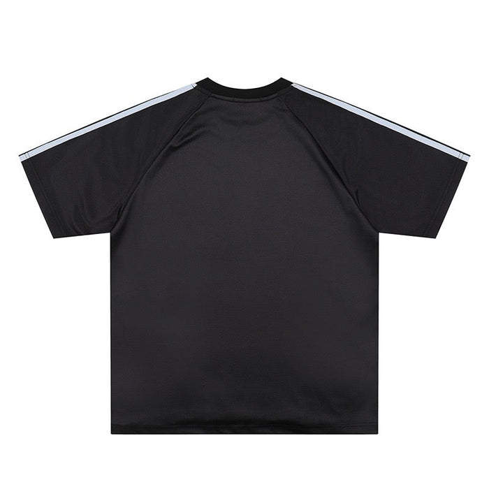 Black mesh soccer jersey tee with raglan sleeves and light gray shoulder stripes on a clean white background