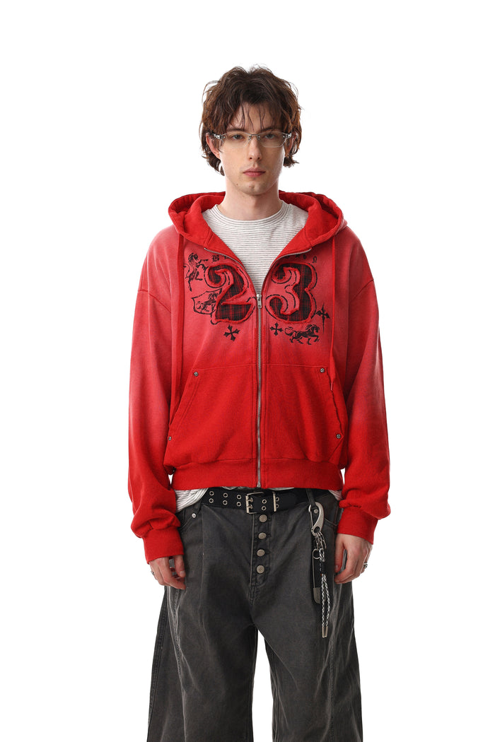 Model wearing red zip-up hoodie with number 23 graphic and distressed wash