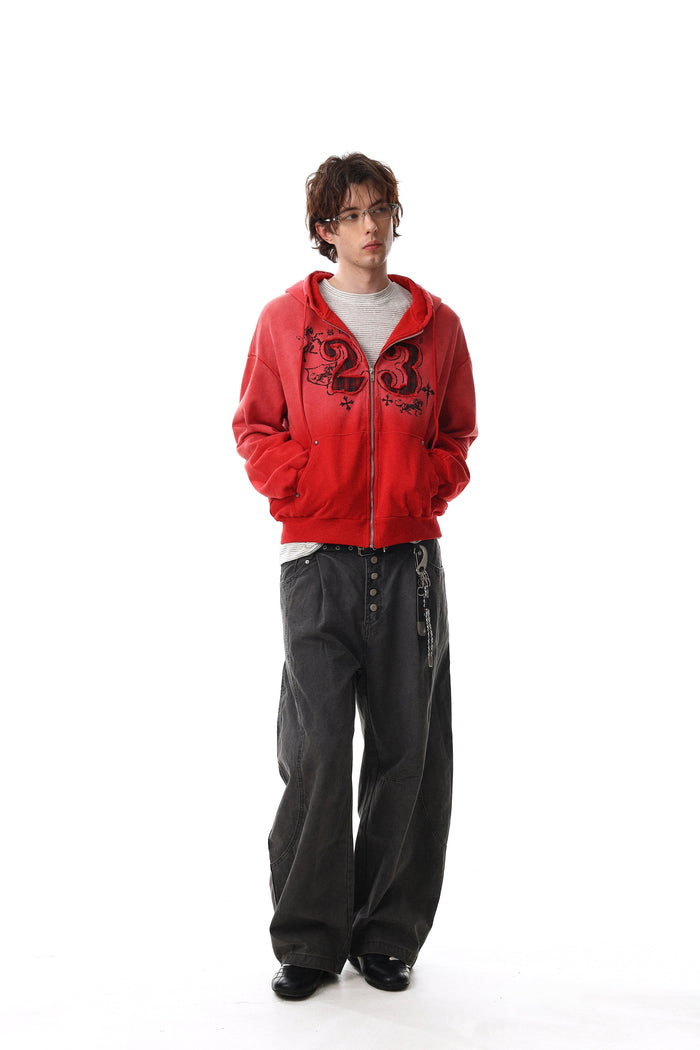 Model wearing red hoodie open over striped shirt with hands in pockets