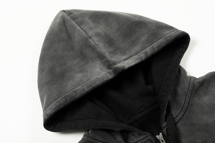 Close-up of black hoodie hood with faded wash and soft fabric texture