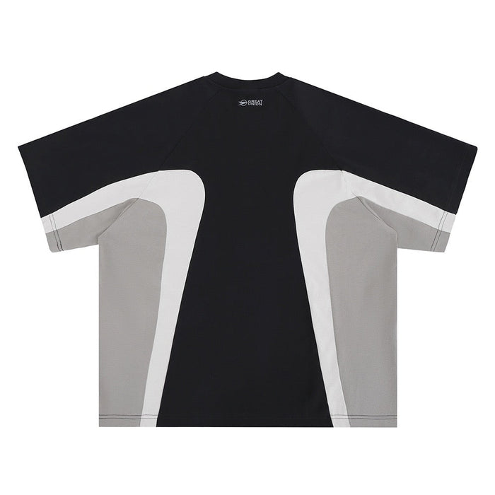 Black colorblock T-shirt with white and gray curved panels, short sleeves, and a futuristic streetwear design