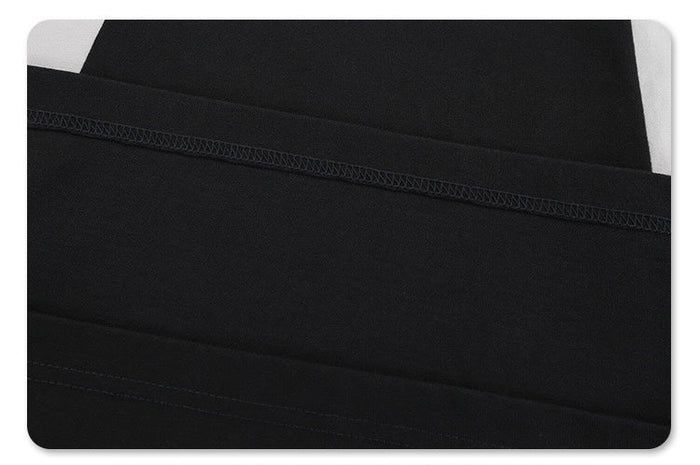 Black colorblock T-shirt with diagonal paneling and visible stitched seams for a sleek futuristic streetwear look