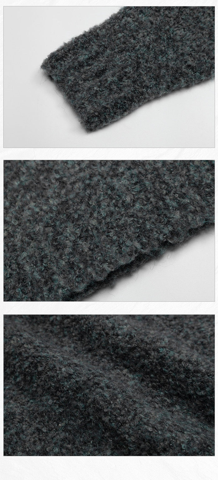 Close-up detail of dark boucle knit fabric showing fuzzy texture and sleeve cuff