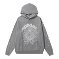 The Sp5der Hoodie – Grey Web 440GSM Heavyweight Oversized Streetwear Pullover features a white spiderweb design, bold “spider” lettering, star details on the sleeves, a front pocket, and a drawstring hood—ideal for streetwear enthusiasts.