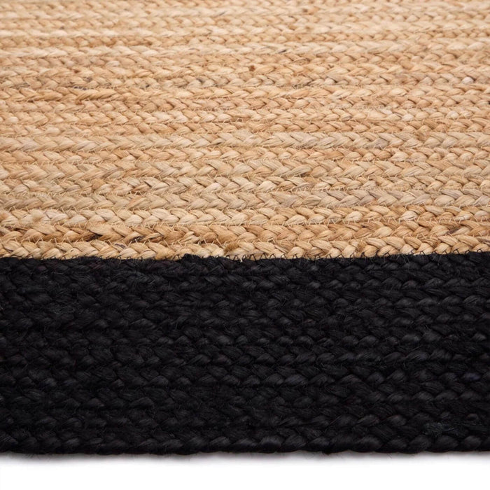 Close-up of a woven rug with a natural top layer and black bottom layer.
