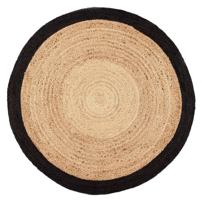 Round jute rug with black border on a white background