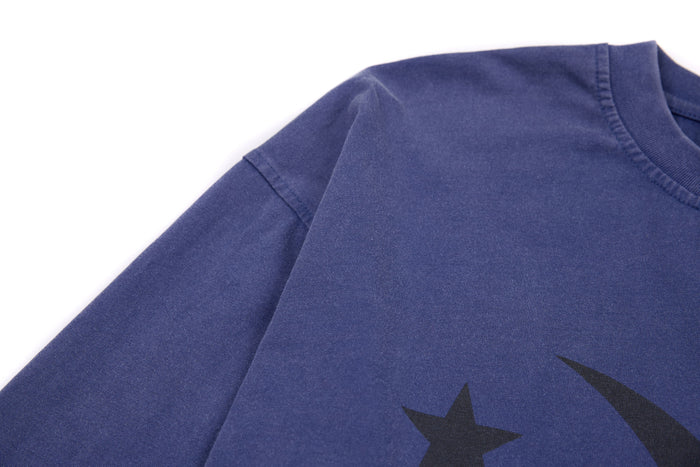 Close-up of blue sleeve and front graphic detail on heavyweight cropped tee