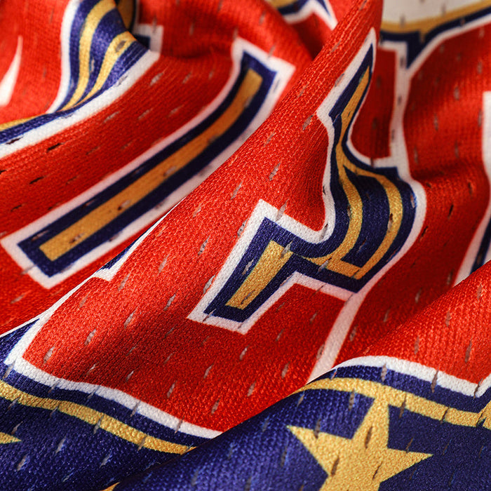 Close-up of red mesh football jersey fabric with bold blue, gold, and white heritage club graphics and star detailing