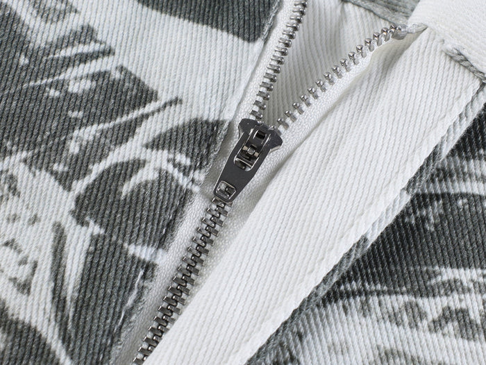 Close-up of metal zipper on gray printed pants fabric