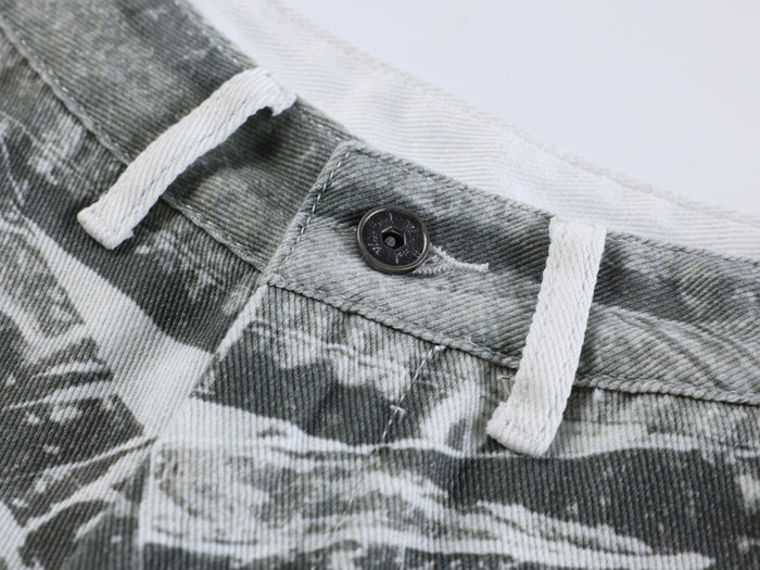 Close-up of waistband button and white drawstrings on gray printed pants
