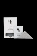 Front-facing product shot of Higher Standards Dot Wipes - Box of 30 with box, single sachet, and a folded dotted wipe on a black background.
