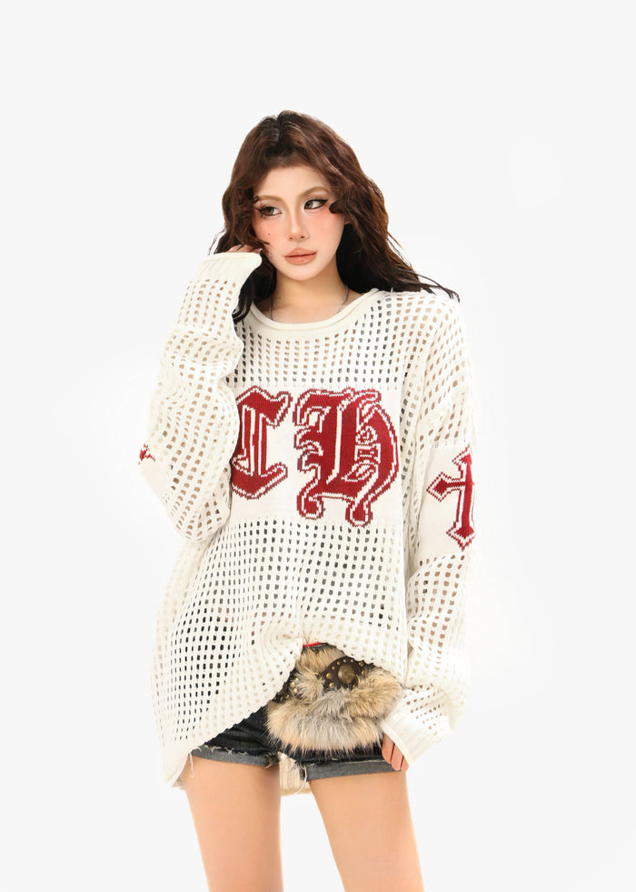 Model wearing cream open-knit crewneck sweater with burgundy CH graphic