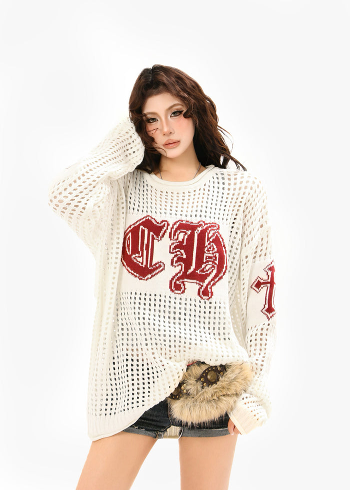 Model wearing cream open-knit sweater with burgundy CH graphic and long sleeves