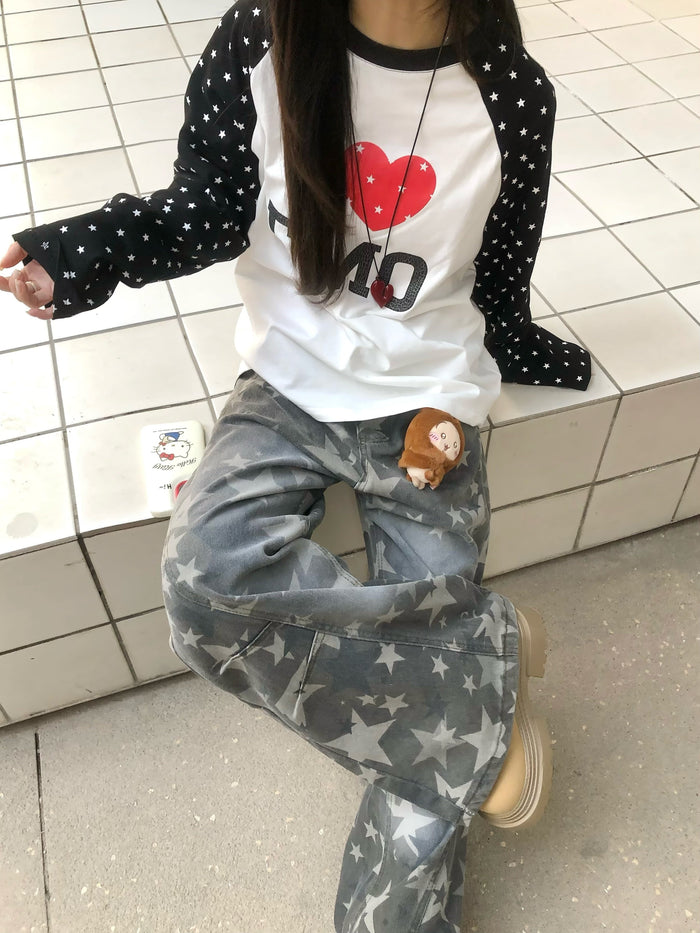Model wearing white I Love EMO raglan long sleeve tee with black star-print sleeves