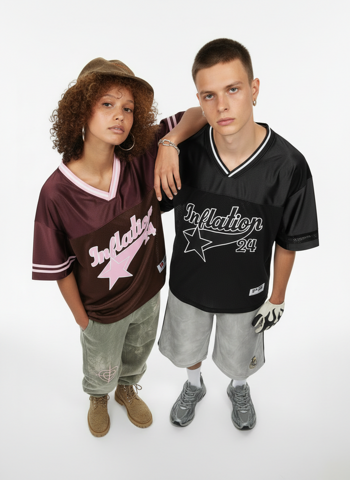 Two models wearing oversized Inflation 24 mesh jerseys, one black and one burgundy, styled with streetwear shorts and sneakers
