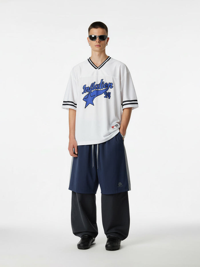 White varsity mesh jersey with blue Inflation 24 star graphic and black striped V-neck sleeves, styled on model