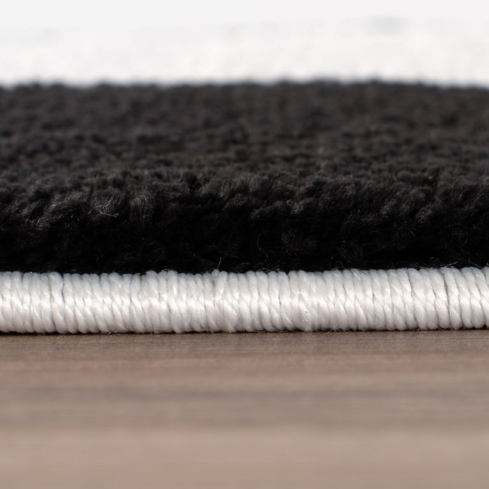 Close-up of black and white textured materials on a wooden surface