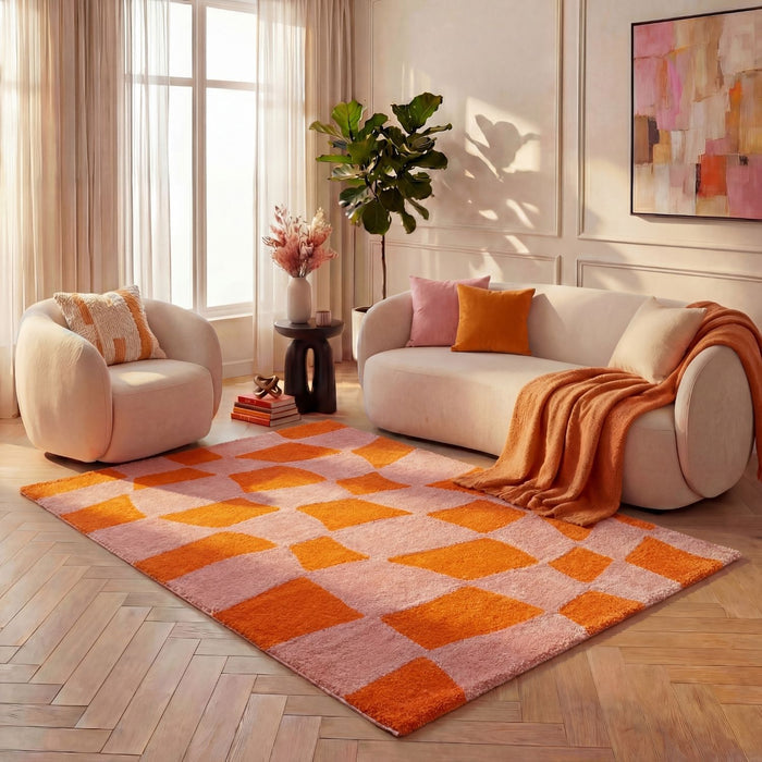 Living room with a checkered orange and pink rug, white sofa, and armchair.