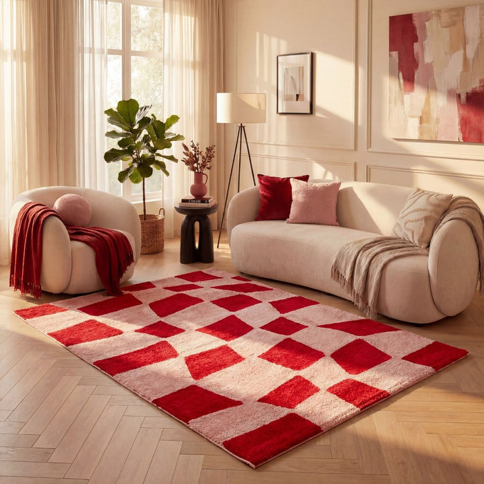 Living room with a red and beige checkered rug, white sofa, and armchair.