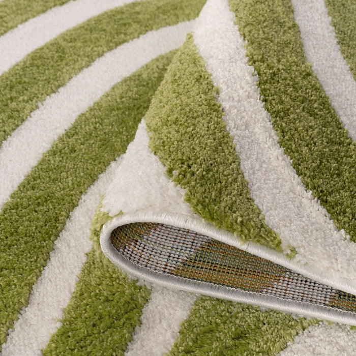 Green and white striped rug with a corner being pulled away
