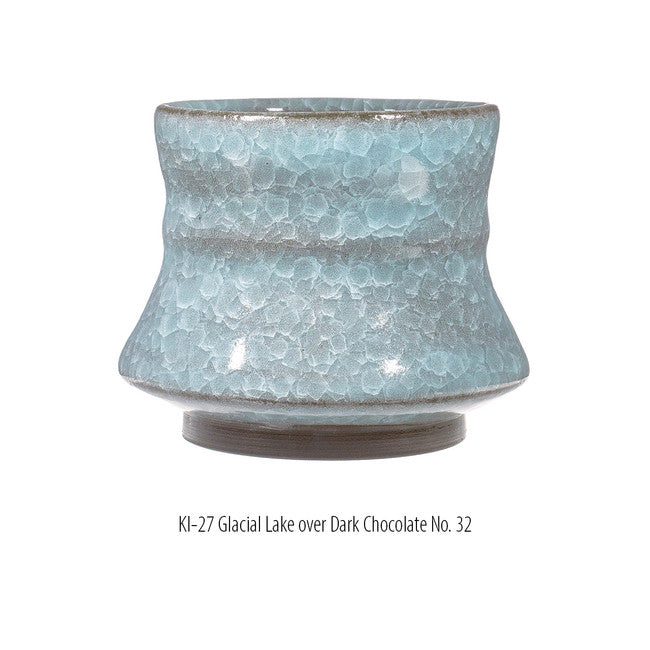 Cup in KI-27 Glacial Lake glaze over Dark Chocolate No. 32 clay, pale blue crackle with a dark bare foot