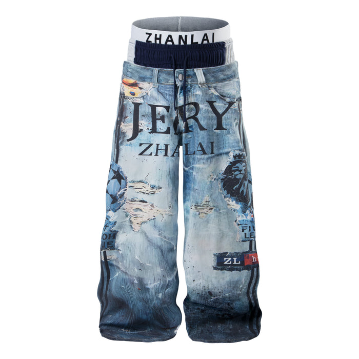 Front view of wide-leg graphic denim pants with layered waistband, distressed print, and lion motif in washed blue
